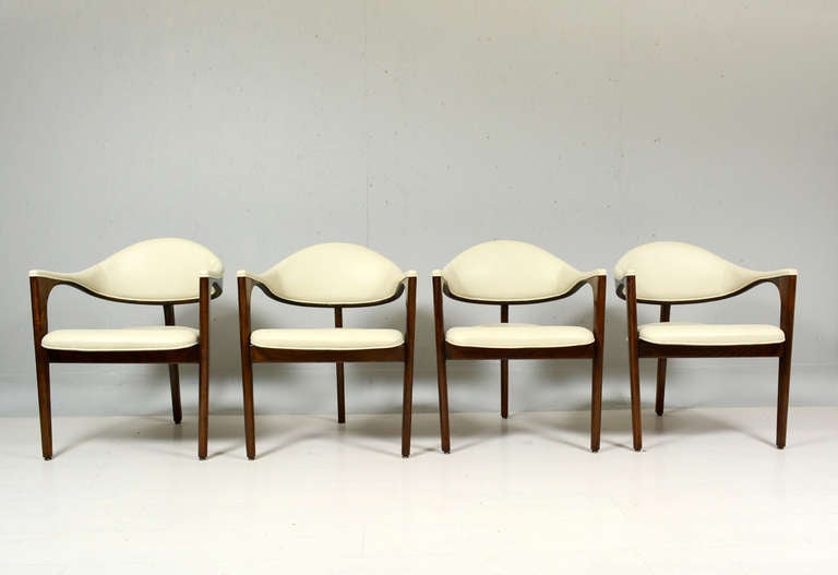 For your consideration a set of four tripod chairs.
Constructed with solid oak wood with new ivory faux leather upholstery.

Sculptural back. very firm and sturdy.

No information on the maker.