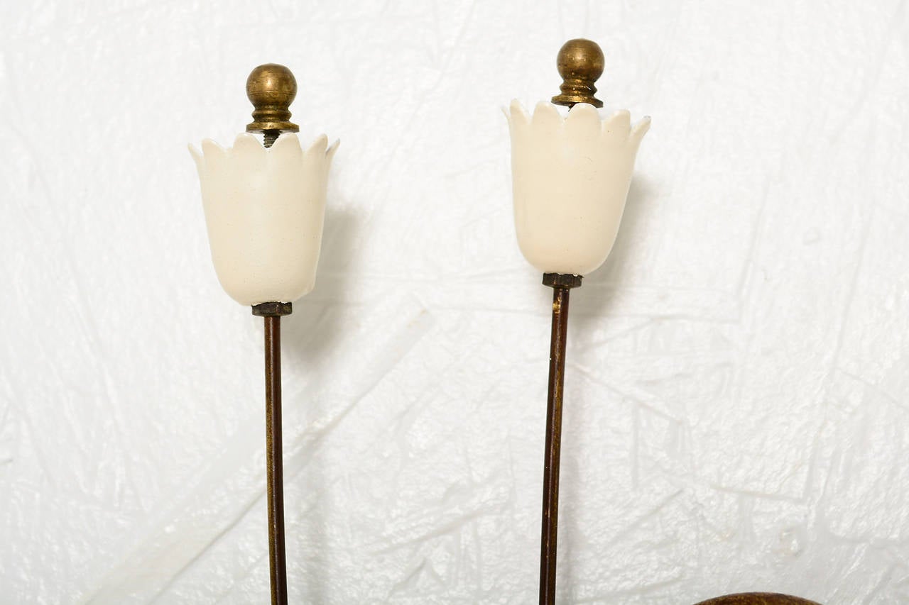 For your consideration a pair of Italian wall sconces.
Beautiful shape with flower shape. 

Aluminum shades in off white color. Brass in original vintage patina. Each sconce requires two E-14 bulbs, 25 to 40 watts.

Rewired and ready to go.