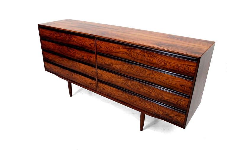Fro your consideration a double dresser by Westnofa in rosewood. Mounted in peg legs. Four pull out drawers on each side. Sculptural pull handle built in with the drawer. Double dovetail construction. Firm and sturdy. Retains label from the maker on