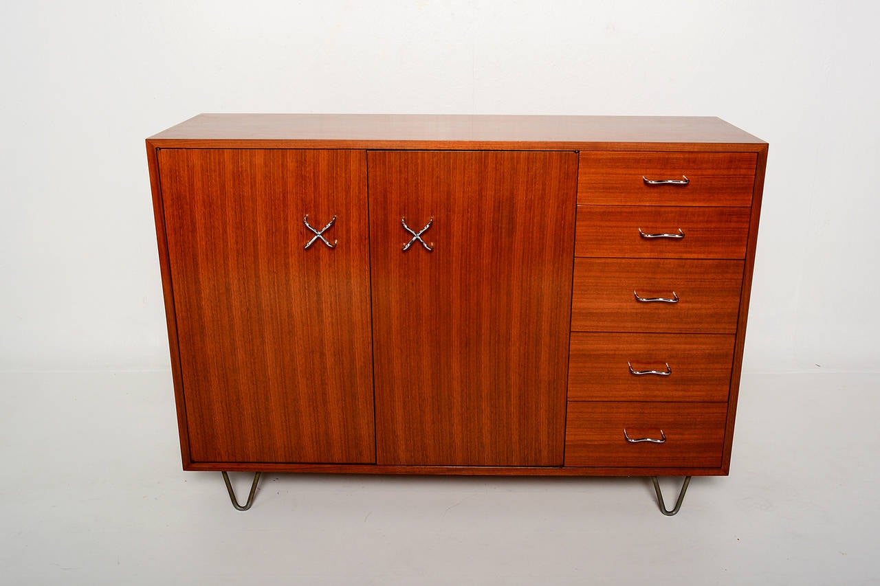 For your consideration a vintage cabinet with hutch designed by George Nelson for Herman Miller.  
Cabinet mounted in orignial hairpin legs. Wood appears to be walnut wood. 

Large storage with pull out drawers. All drawers constructed with