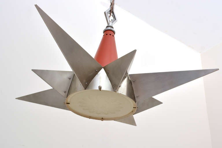 For your consideration a vintage hanging chandelier in the shade of a compass star. Spun aluminum code in red/orange color. Aluminum star shape has four large and four small triangular shades. The lamp works with five bulbs. Four of the bulbs fits
