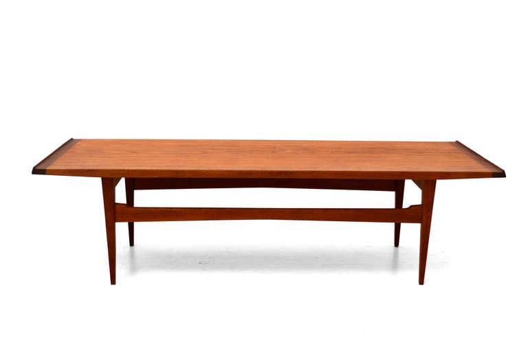 Danish modern teak coffee table created by Moreddi, Denmark circa 1960s.

Beautiful wood grain with sculptural lips on the sides of the table. 

Legs can be removed for safe and easy shipping. 

Stamped underneath with makers information.