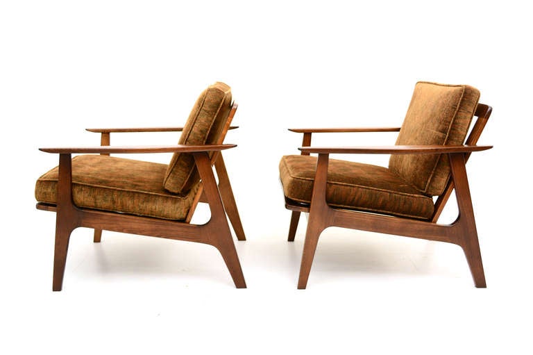 Pair of mid-century modern lounge chairs made in Japan.

Finished in walnut tones with new upholstery.