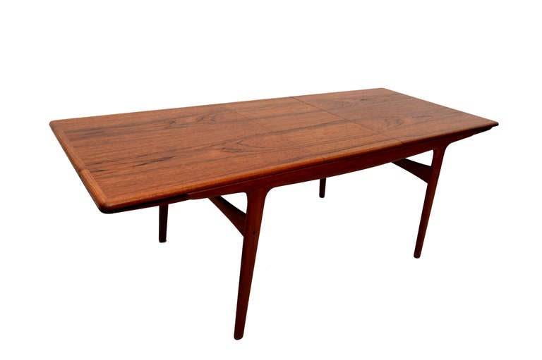 Mid Century Modern teak dining table with two extensions. Sculptural construction. 

Attributed to Kofod Larsen based on  style. There are no markings from the maker.

Table can be taken apart for safe and easy shipping. 

Fully extended, 98
