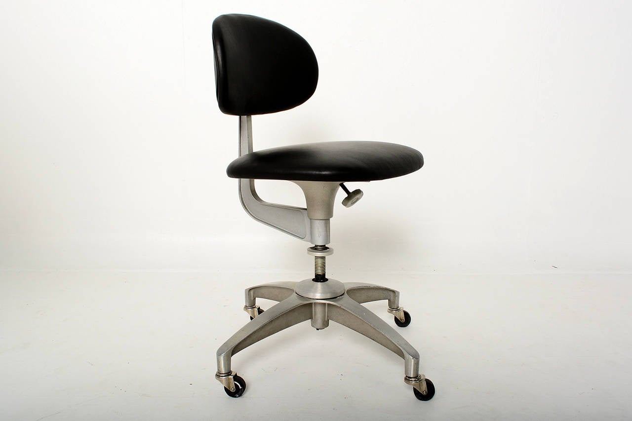 Offered for your consideration a vintage office chair with great character. 
Body in solid aluminum can be polished if desired. 

Back rest and seat upholstered with new black leather. Very soft and very comfortable. Seat height is adjustable,