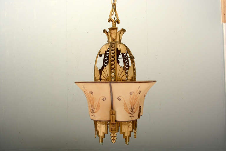 Late 1920s art deco slip-shade chandelier. Cast aluminum with intricate art deco detail throughout exterior and interior. Frame signed; 