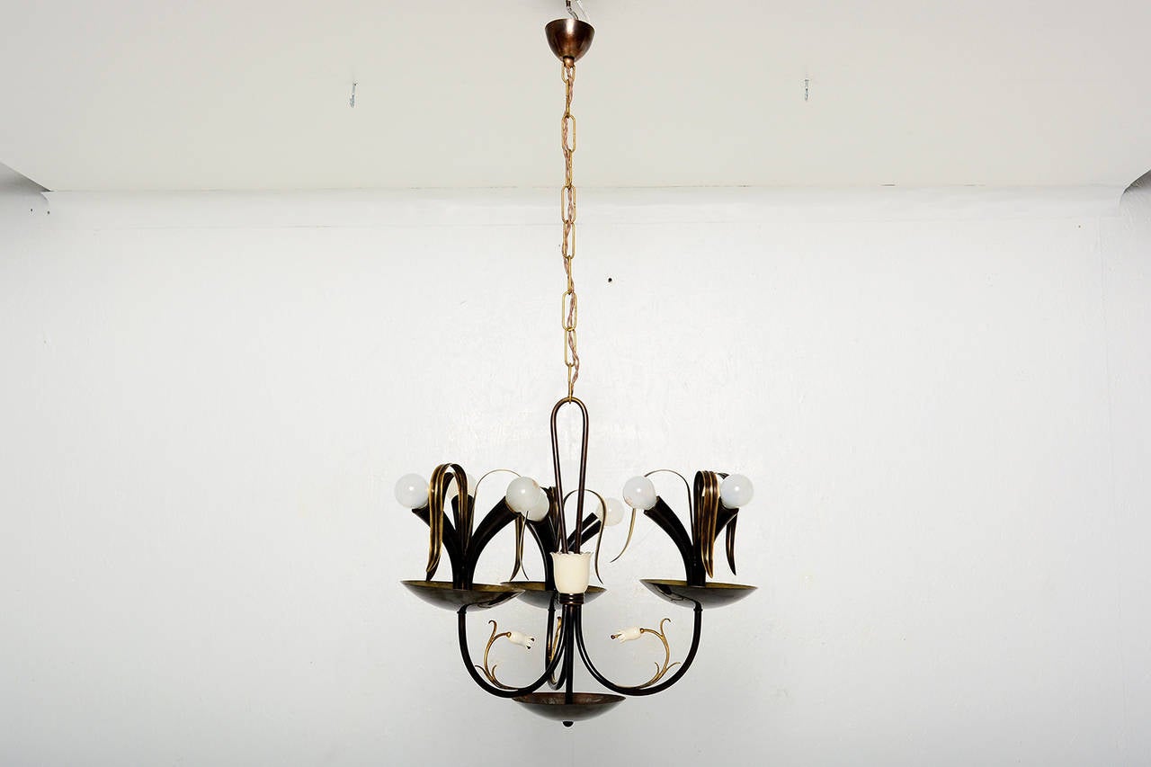 For your consideration a vintage Italian chandelier. Patinated brass looks llike a flower arrangement. 

Beautiful design. Requires nine (9) E-14 bulbs (25 to 40 watts) . The chandelier has been rewired and it is fully restored.

No info on the