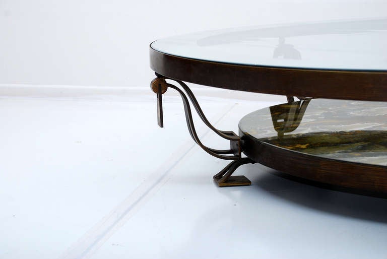 For your consideration a round cocktail table constructed with solid brass and custom glass. 

Beautiful attention to details. 

Two tier table mounted in five legs.
