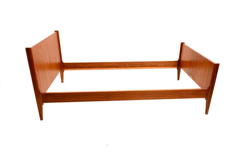 Made in Denmark by Dyrlund , this wonderful single bed or day bed can be used in the guest room or even in the main room since the headboard and foot boards are finished on both sides. 

Sculptural clean modern lines. Teak wood grain is just