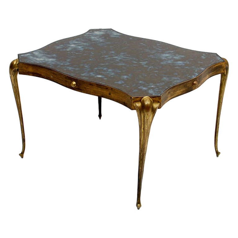 For your consideration, 

A one of a kind side table.

The whole construction is made of brass. Legs can be removed for safe and easy shipping.  

Original eglomized glass top.  Original vintage patina.