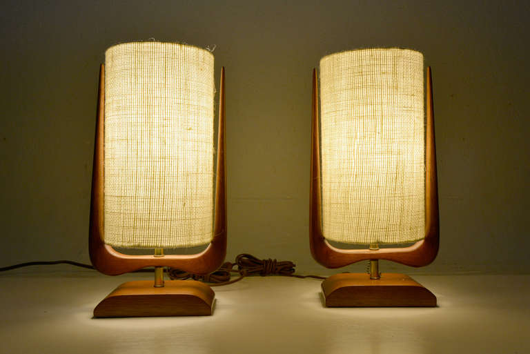 For your consideration a pair of table lamps constructed with sold mahogany wood. Sculptural wood shape with new drum shade in white burlap.