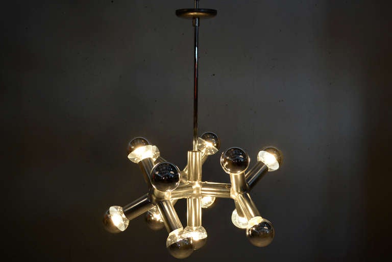 For your consideration a vintage chandelier by Robert Haussmann.
Atomic/molecular shape in anodized aluminum with (13) half chrome bulbs (25 watts per bulb).

Each bulb is 2 3/4" in diameter. 

The current rod to the ceiling is 17" H.

 