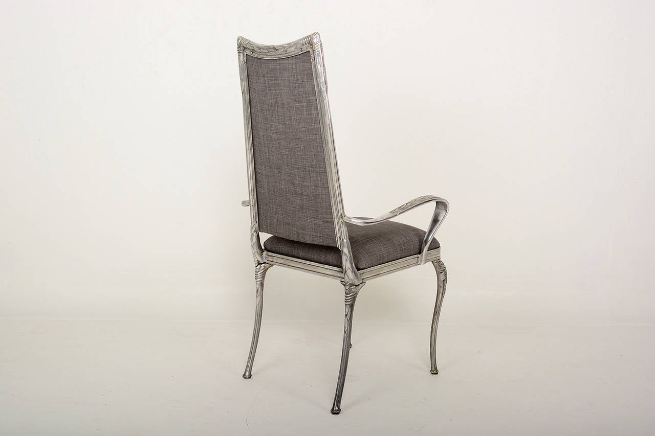 For your consideration a set of four dining chairs made of solid aluminum with new upholstery in grey color. 

The chairs are very comfortable. Chairs have a sculptural shape with nice decorative details.

Unmarked, no info on the maker or