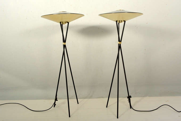 For your consideration a pair of tripod floor lamps constructed with aluminum painted in flat black with original fiberglass shades and brass hardware. 

Beautiful sculptural design. Lamps can be used outdoors.

Unmarked, produced by MOE light. 