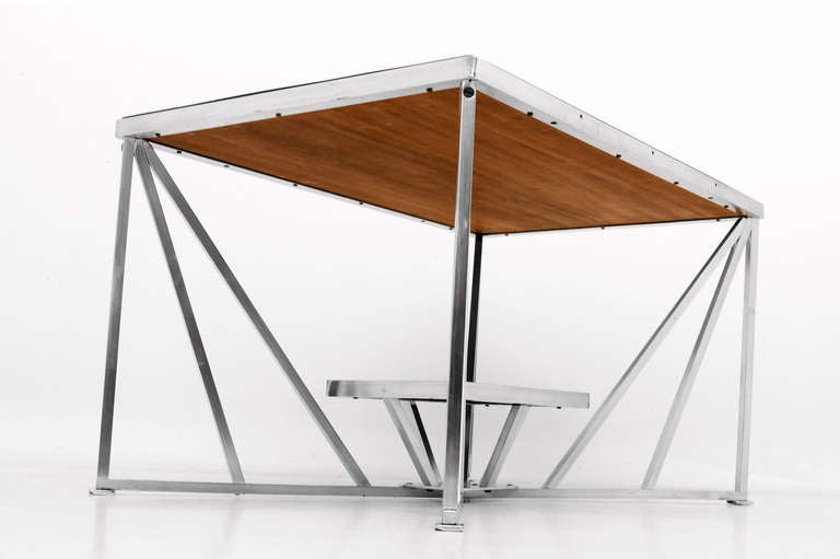 Important art deco coffee table constructed with solid aluminum and   wood top.

Two tier table with very unique and clean modern lines. 

Wood has a walnut finish. 

USA circa 1930s. 

