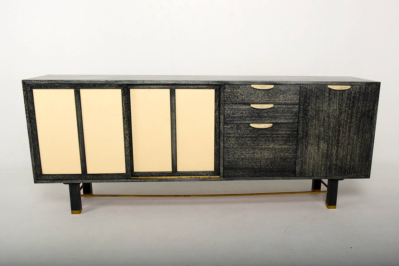 For your consideration a vintage credenza by Harvey Probber.

Cerused mahogany finish (black and ivory). Doors covered in leather. Brass accents. 

Stamped with makers label in top drawer.