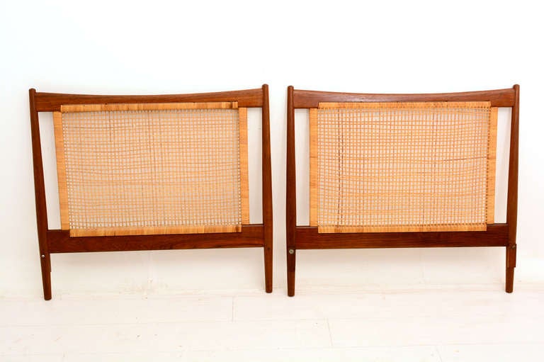 For your consideration a pair of matching headboards. Made in Denmark Circa late 50s. Solid teak wood with sculptural shape and cane back. 