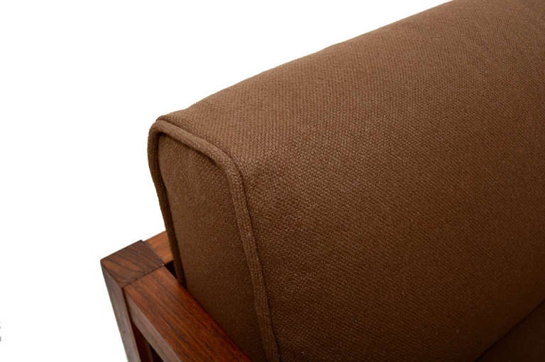 For your consideration a mid-century modern rosewood sofa made in Japan. 

Beautiful rosewood with simple and clean modern lines. 

New upholstery in brown  tone.  Very comfortable. 

Original spring system underneath the long cushion. 

Arm