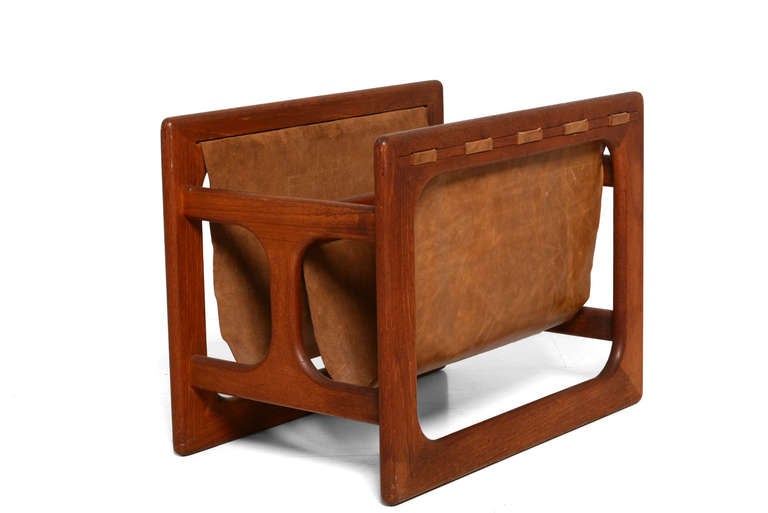 For your consideration a teak and leather magazine holder.

Sculptural construction with new leather.