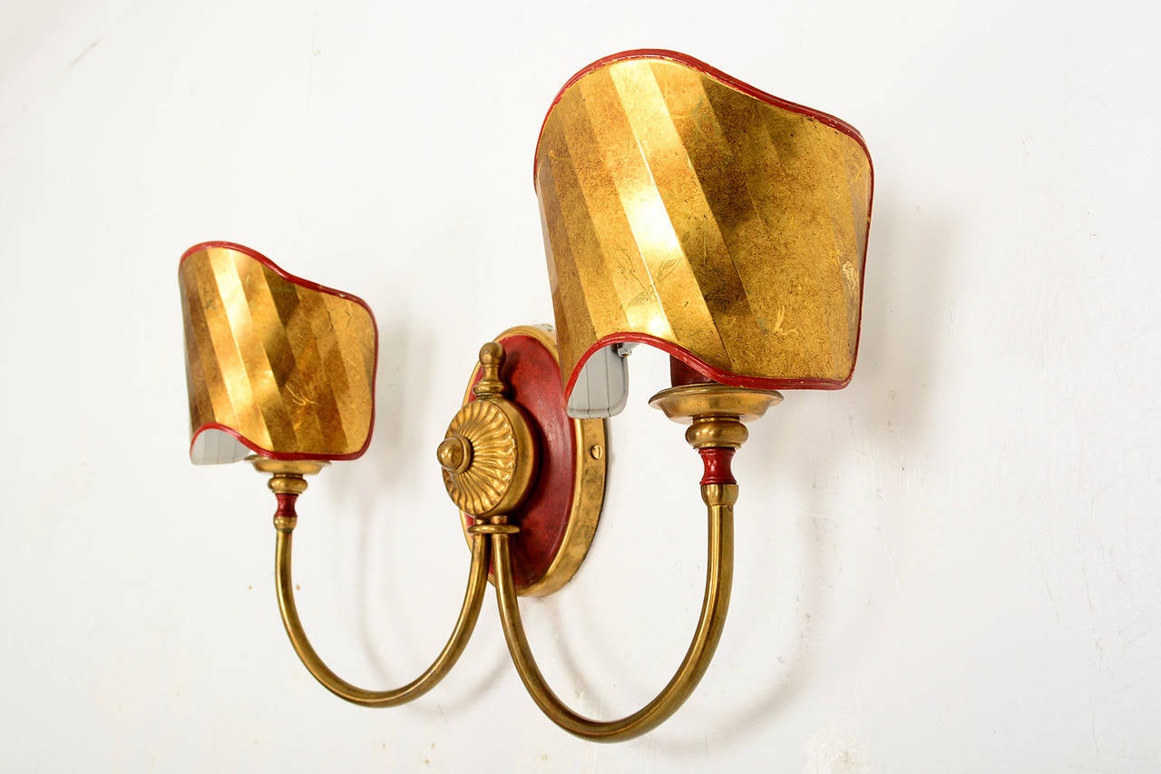 For your consideration a pair of Italian wall sconces with nice decorative brass shield.