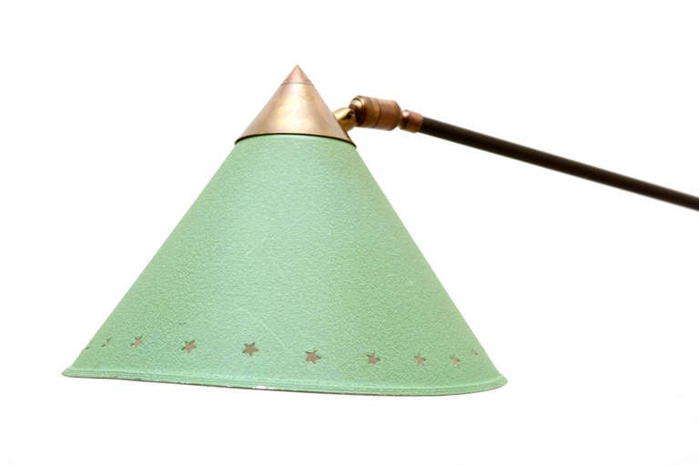 For your consideration a vintage wall sconce in the style of Pierre Guariche. 

Conical shade constructed in aluminum with iconic star perforation. Brass hardware with nice vintage patina. 

Lamp has been rewired and it is in excellent working