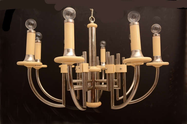 AMBIANIC presents:
Art Deco Regency Modern Eight Arm Chandelier in Bakelite Chrome-Plated
White Bakelite Accent Pieces on Chrome-plated Tubular Steel.
Dimensions: 34 tall x 31 inches diameter. 
Timeless elegant design acquired from the estate of