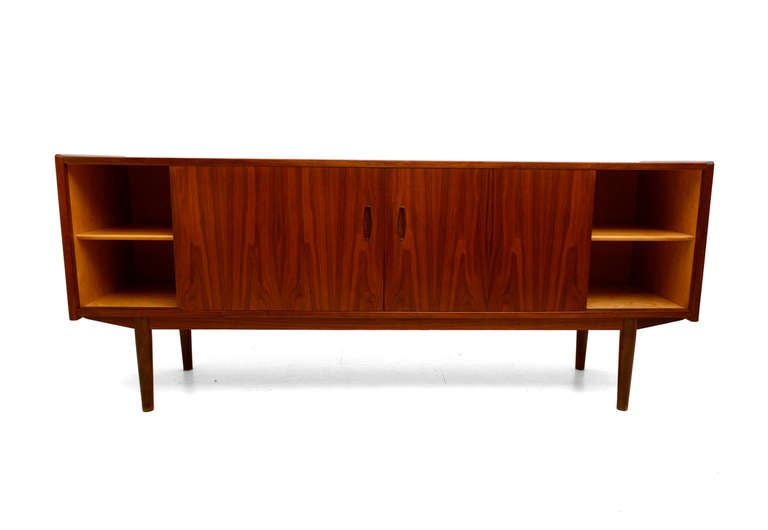 For your consideration a mid-century danish modern teak credenza designed by Nils Jonsson, for Hugo Troeds. DUX export label underneath the credenza.

Features five pull out drawers constructed with double dove tail joints. 

Open storage on