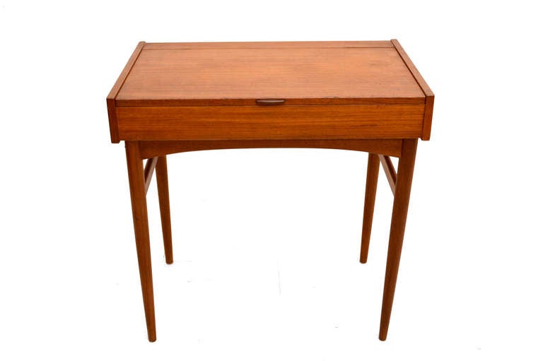 For your consideration a functional furniture, closed can serve as a small desk, once you open the table top, it serves as a vanity. The top door open a closes with ease.

Built with teak wood, clean modern lines and sculptural legs and handle.