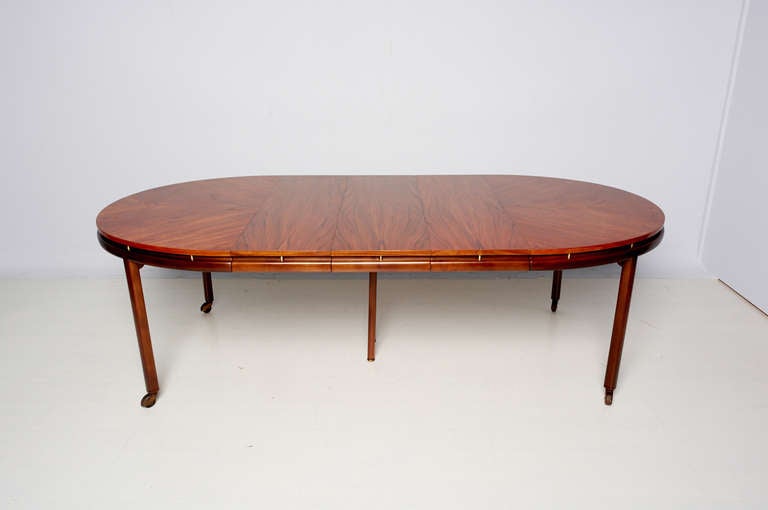For your consideration a 1950s dining table by Michael Taylor for Baker. Walnut top and brass accent details with three 14