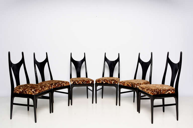 For your consideration Eugenio Escudero 1950s set of six manta ray style dining chairs in black lacquer wood with original upholstery 

Change of upholstery can be done at no extra charge. Customer to provide the upholstery.