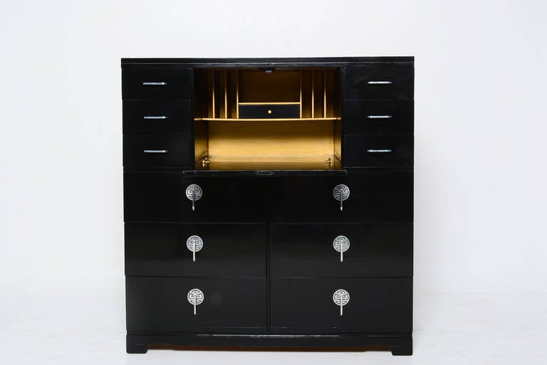 For your consideration a secretary desk/cabinet in the manner of James Mont.
Asian inspired handles with high gloss black lacquer finish. Desk section finished in gold color. 

Features four large pull out drawers and six small drawers on top. In
