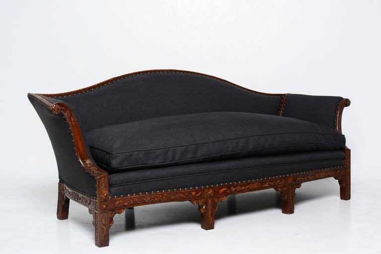 For your consideration an antique sofa with carved wood frame and feather down cushion. 
Upholstered in dark gray color. 
Beautiful classic lines with nice hand carved decoration. 

No markings form the maker.