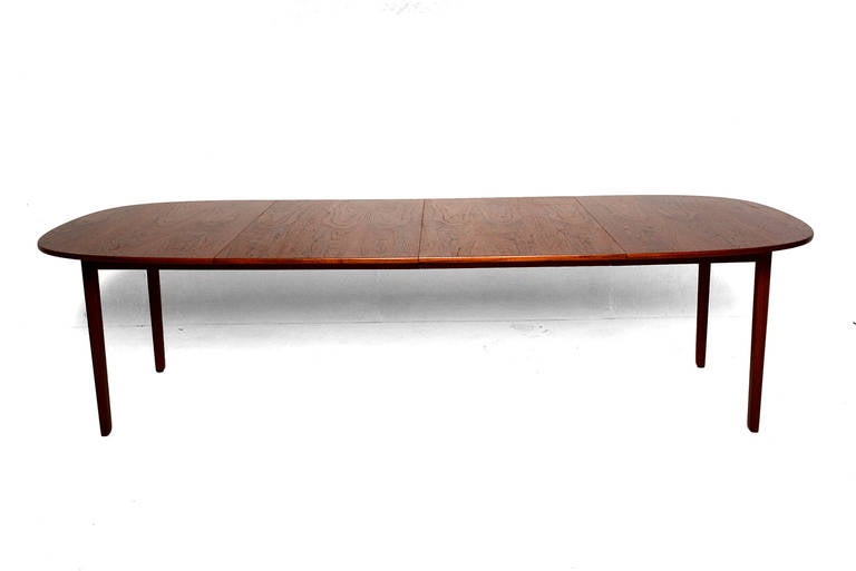 For your consideration a beautiful teak dining table design by Ole Wanscher. 
Table has two removable extensions measuring 25 3/4