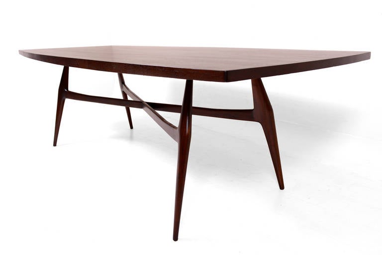 For your consideration a beautiful dining table attributed to Eugenio Escudero.

Constructed with mahogany wood. Sculptural tapered legs. Table top have also sculptural shape with rectangular shape. The edges of the table have a sculptural curved