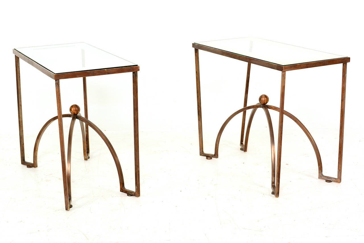 For your consideration a custom-made pair of side tables in solid brass frame and glass top (with silver/mirror) band.

Clean modern lines.