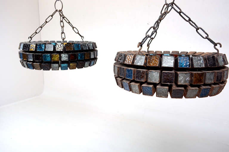 For your consideration a pair of hanging chandeliers.

Round shape with multiple colored glass tiles. 

Chandeliers retain original hanging chain.

The fixture measures 19