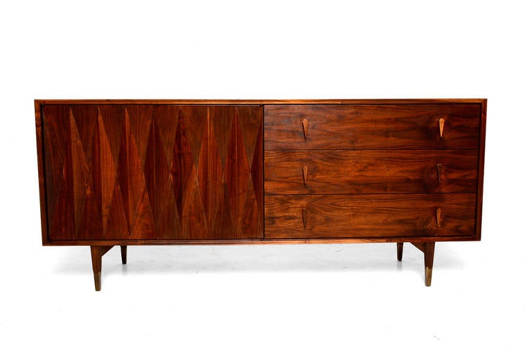 For your consideration an sculptural walnut credenza or dresser designed by Albert Parvin. 

Beautiful diamond design in the doors. All drawers open and close with ease. 

Sculptural pull handles in solid walnut wood. 

Brass accent on the peg