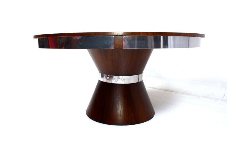 For your consideration a custom made mid-century modern round dining table.

Walnut veneer on solid wood with mirrored stainless steel accents. 

Round top with sculptural base.