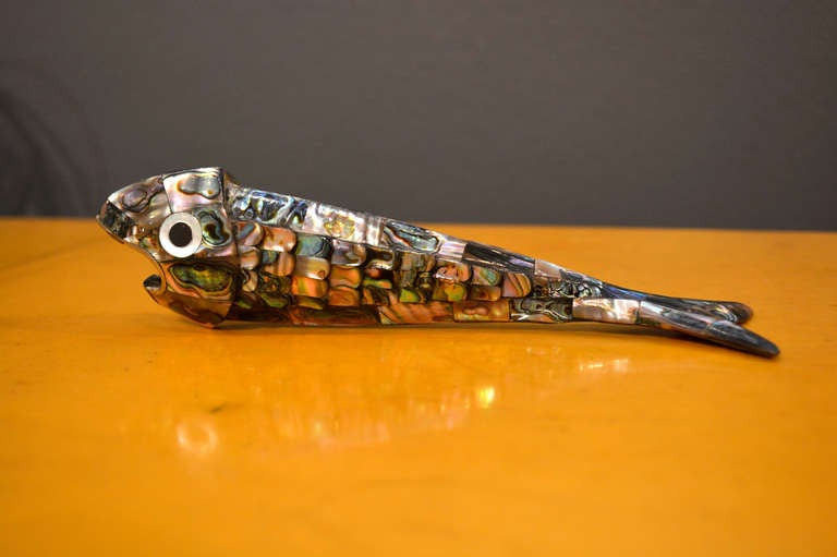 For your consideration a vintage fish bottle opener by Los Castillo.

The bottle opener is firm and sturdy there is no body movement. 
Beautiful work with mother-of-pearl and what appears to be silver or silver plated.

The fish has the marking