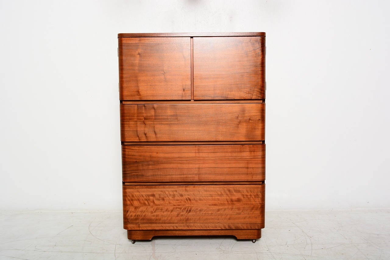 For your consideration a Highboy designed by Paul Goldman for Plymold.

Beautiful walnut grain selection. Drawers and doors have the bent curved finish around the edges. All drawers open and close with ease.