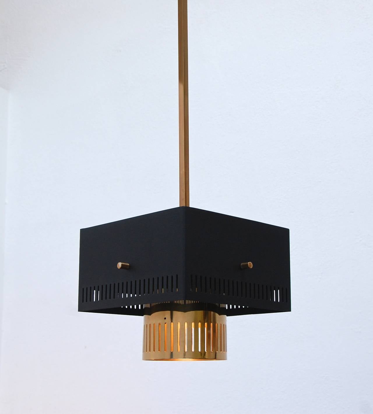 Sharp cubic steel and brass pendants from Italy with perforated shades and glass diffusers.

Drop: 46