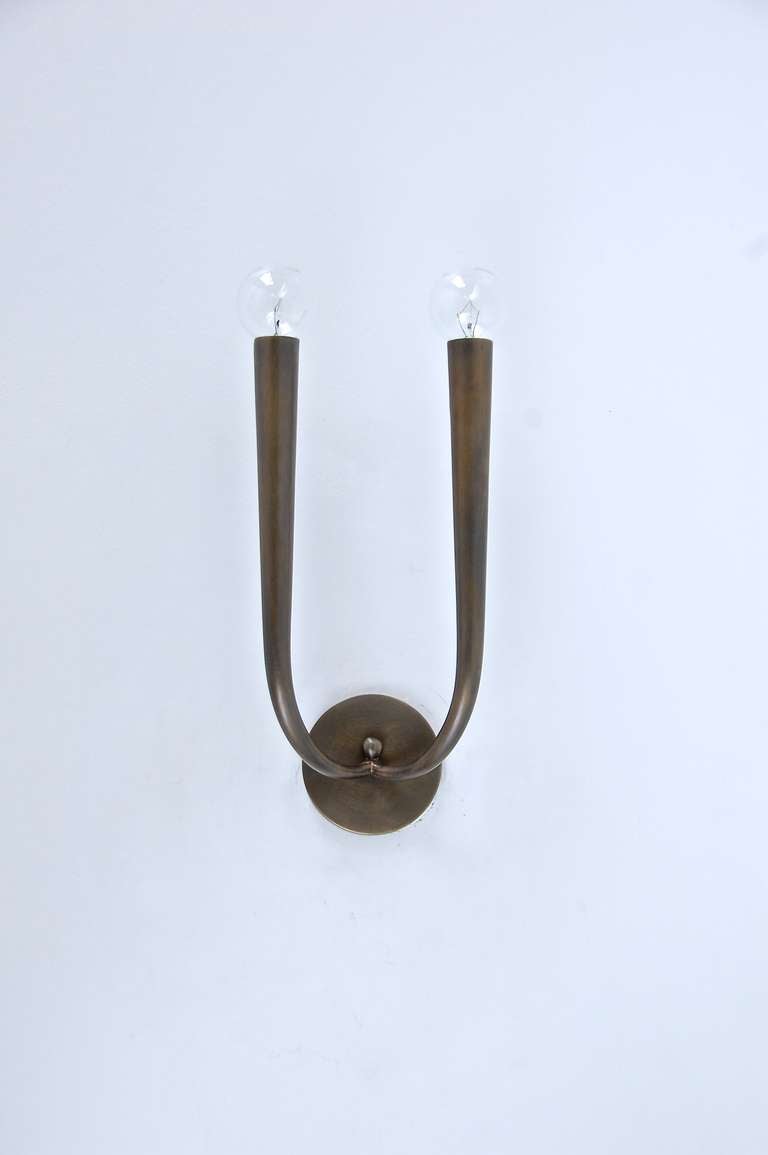Graceful yet rustic striking sconces from Italy attributed to Gugliermo Ulrich in a naturally aged patina brass.