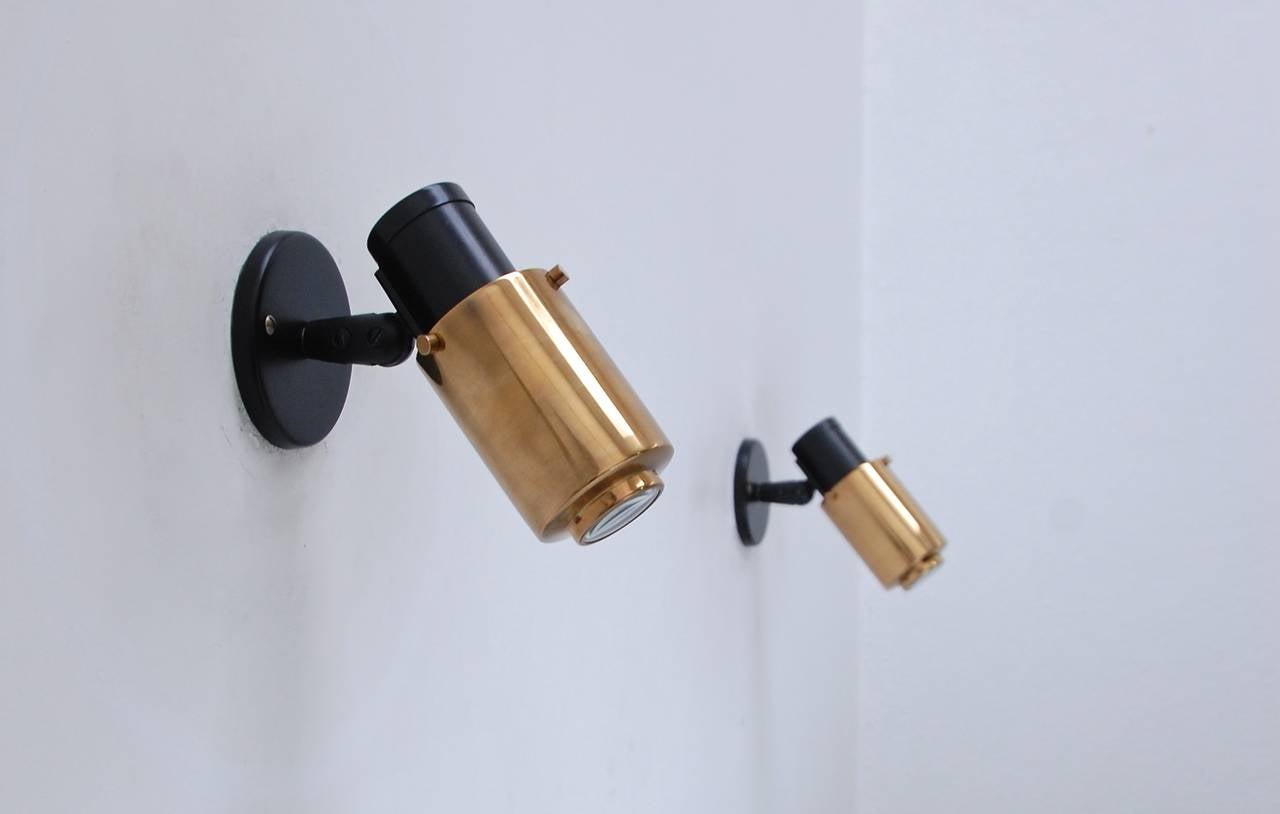 A pair of dynamic and sharp articulating brass and steel reading light sconces by Jacques Biny for Lita. Beautiful magnifying glass lens in shades create a glowing light effect. All rewired for use in the US.