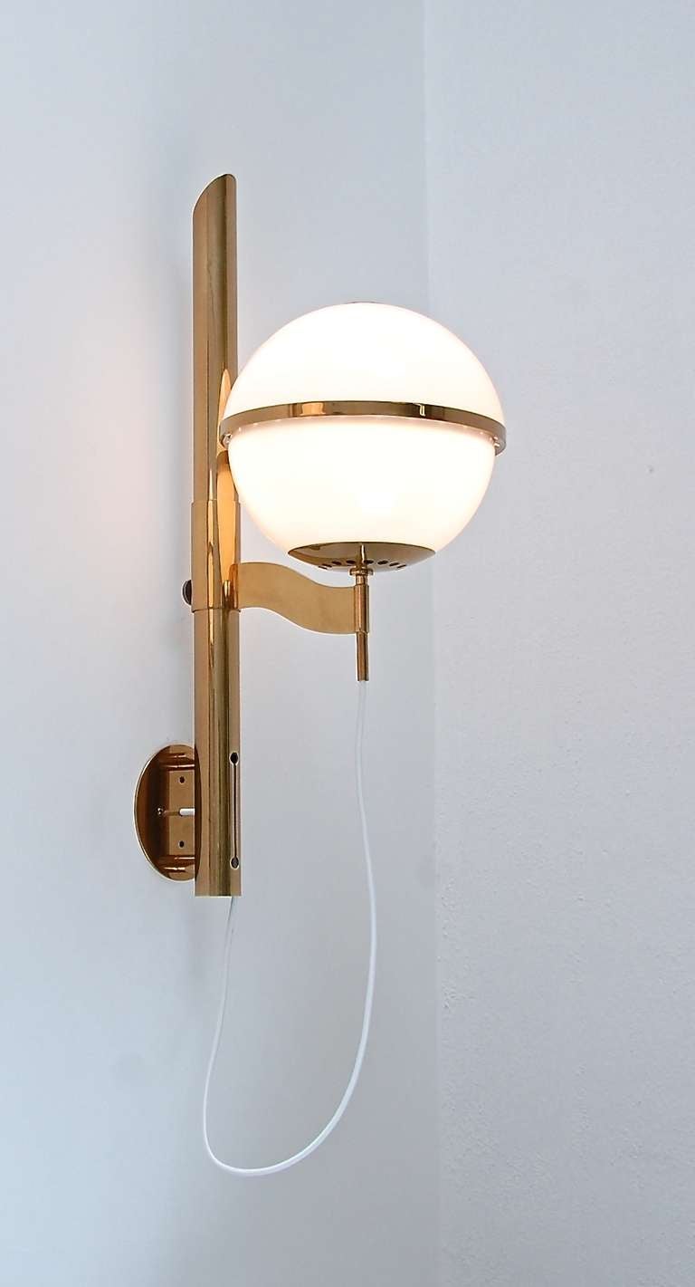 Gorgeous brass and blown glass large wall scones/lamps from Italy by Artemide. Large glass shades slide up and down along center post for height adjustment.