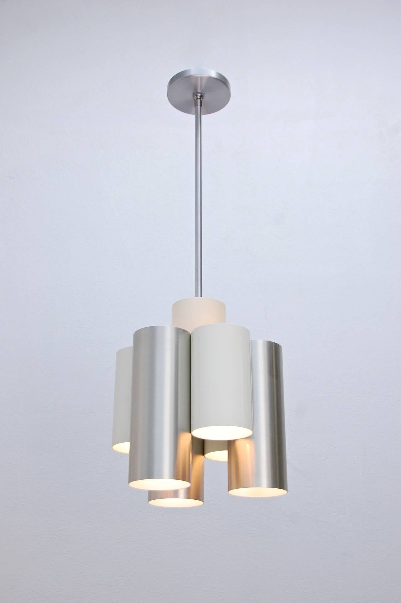 Modern cylinder motif pendant with (6) candelabra based lights from Italy. Soft light casts downward.

OAD: 33