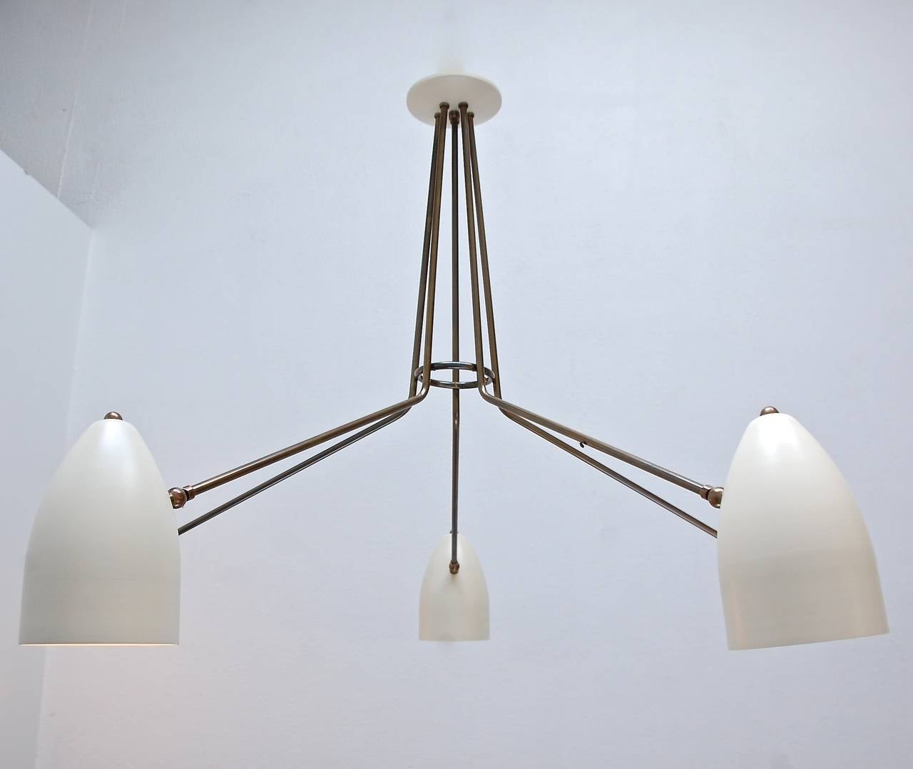 Beautiful Minimalist five-arm flush mount chandelier with five cone shades that pivot up and down for varied lighting. Light brass patina finish and painted aluminum.
E26 based socket per shade.