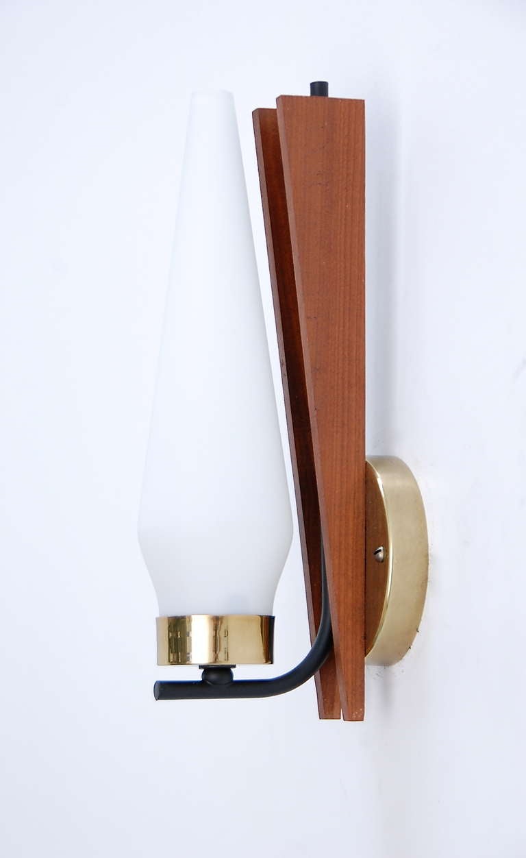 A pair of simple and organic Scandinavian sconces imbibed with classic mid-century design characteristics. With frosted glass shades, these sconces emit a soft and soothing light quality.