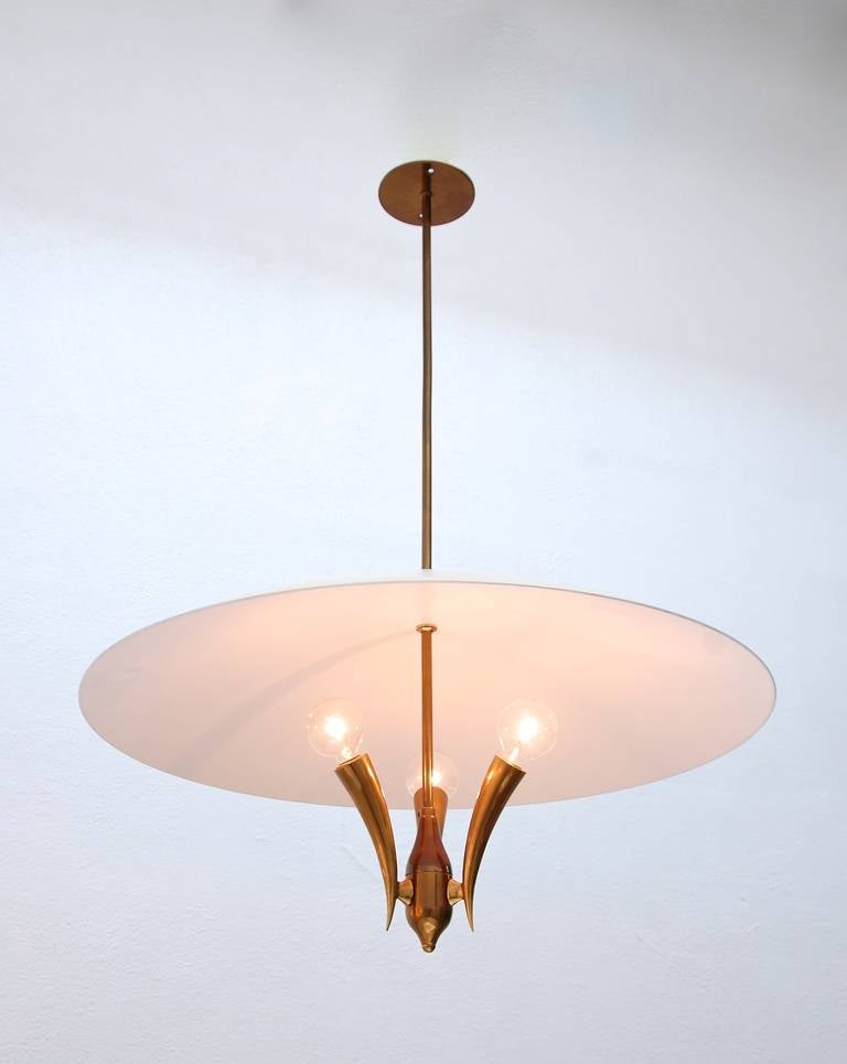 Unique Italian pendant. The caste brass fixture, possibly a Guglielmo Ulrich, has an exquisite finish, off-white and white painted aluminum shade and sharp forms.

Drop: 33