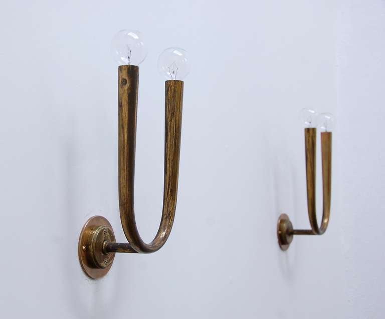 Amazing rare Gugliermo Ulrich brass sconces. Naturally aged with original finish. Fully rewired for use in the US.

Height with bulbs: 11.5