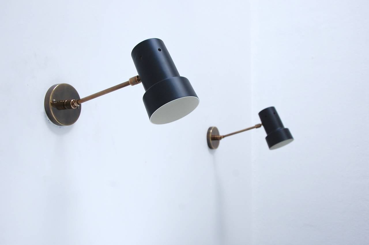 Timeless articulated Italian wall sconces in a black and brass finish. Eight sconces are available.